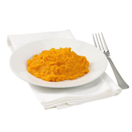 White plate with orange mashed carrots on a white background.