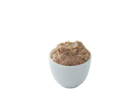 White bowl filled with brown food on a white background.