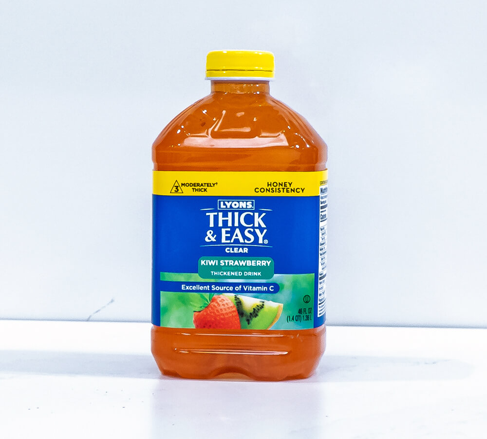 Bottle of Lyons Thick & Easy Kivi Strawberry thickened drink on a white background.