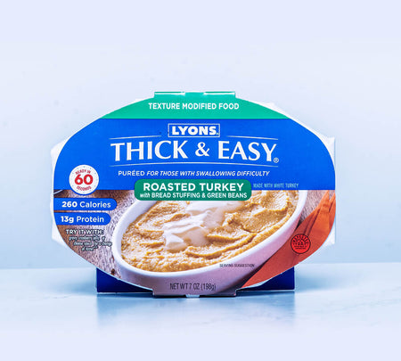 Packaging of Lyons Thick & Easy roasted turkey with bread stuffing and green beans on a light blue background.