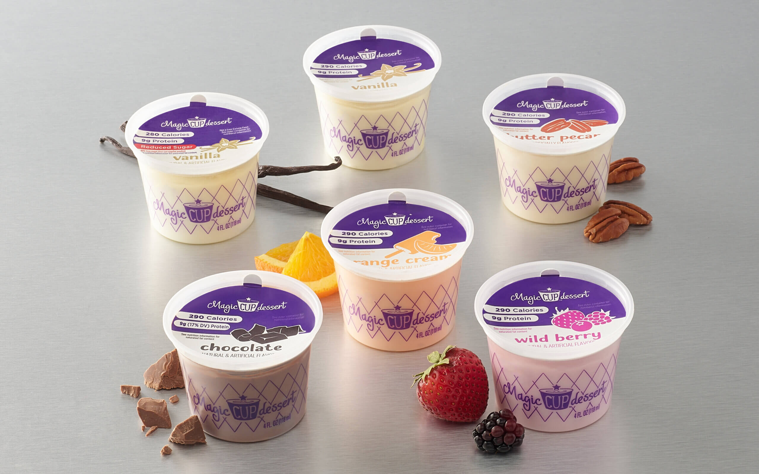 Assorted containers of King Arthur frozen yogurt on a gray background.