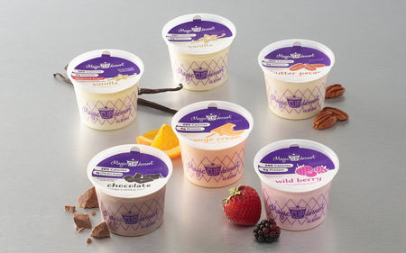 Assorted containers of King Arthur frozen yogurt on a gray background.