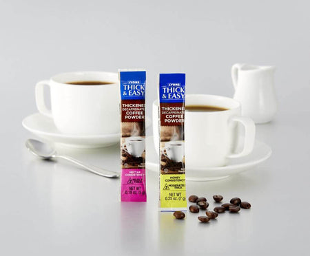 Two packets of Thick & Easy thickening coffee powder with a cup of coffee and coffee beans on a white background.