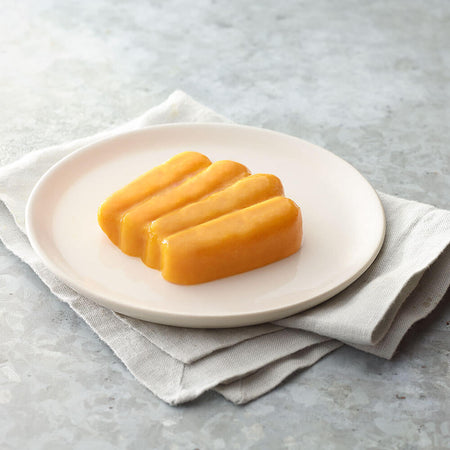 Three pieces of carrots on a white plate with a light gray background.