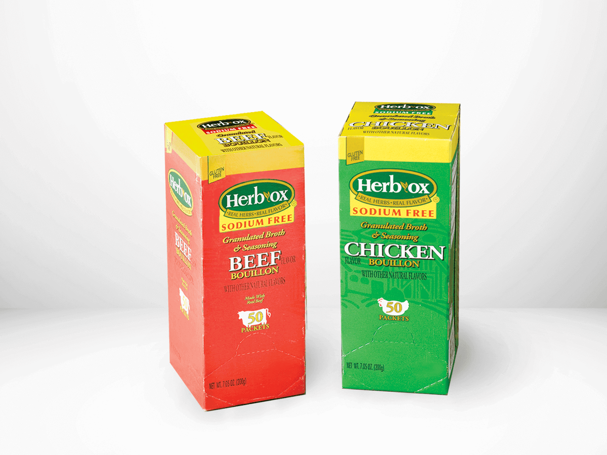 Two boxes of Herb-Ox bouillon, one red for beef and one green for chicken, on a white background.